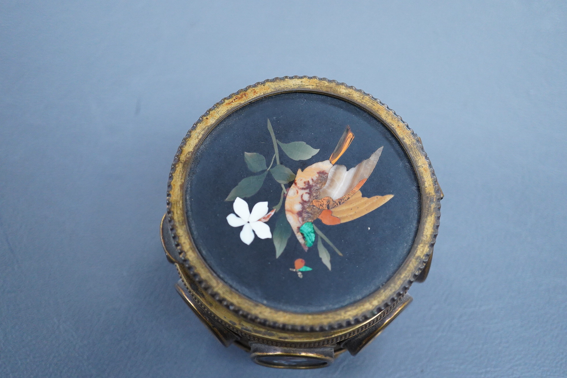 A Victorian pietra dura gilt metal circular box with hinged lid, 7.5cm in diameter